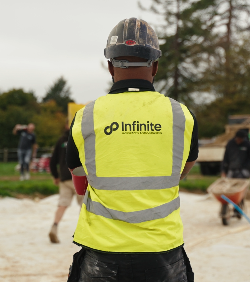Member of the Infinite Landscaping team on site wearing branded workwear